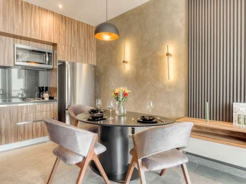 Chic dining nook under a warm pendant, an easy spot for coffee and quiet meals
