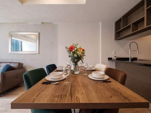 Inviting dining table set with fresh flowers by the kitchen, gather for a meal after exploring the Reforma corridor