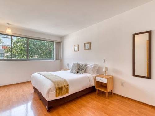 Serene second bedroom with a comfortable king bed and soft natural light, a calm place to rest