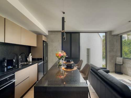 Modern kitchen with a dining counter and full appliances, everything you need for a meal at home