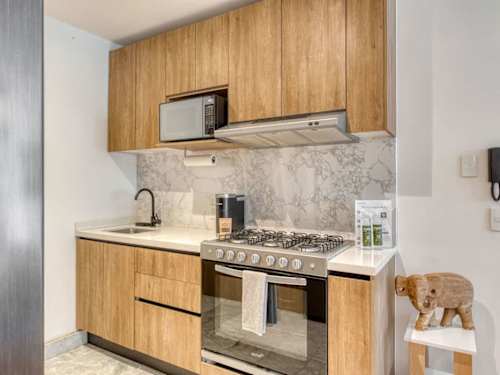 Warm wood kitchen with a gas range and microwave, everything you need to cook a proper meal in