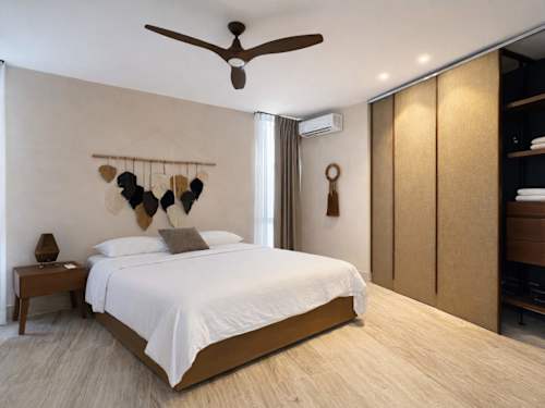 Bedroom with king-size bed and ceiling fan