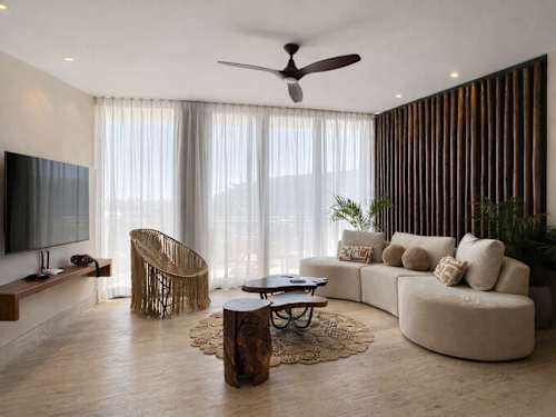 Open-concept living room with sofa and natural light