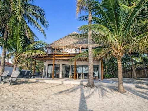 Beach palapa with sun loungers on the private sandy shore