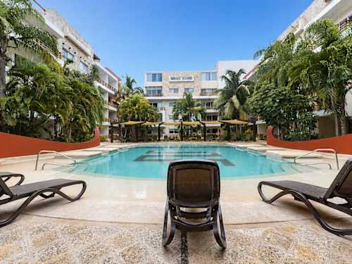 Shared resort pool and sun loungers
