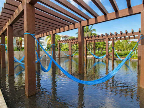 Shared resort pool with palapas