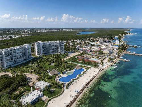 Aerial view of the beachfront resort community in Puerto Cancun, turquoise water and white sand at your doorstep