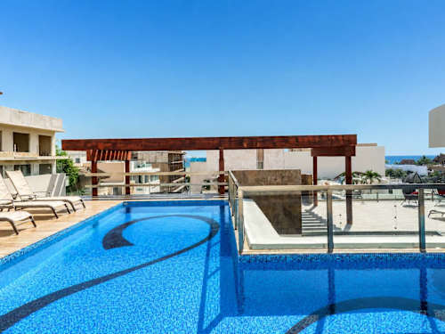 Shared rooftop pool with ocean views