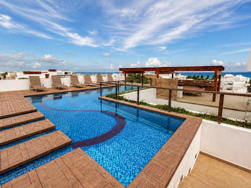 Shared rooftop pool with ocean views