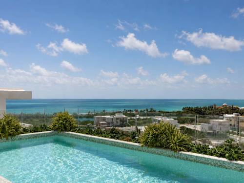 Shared rooftop infinity pool with ocean views