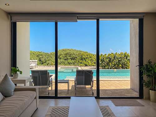 Terrace seating with sea views through glass doors