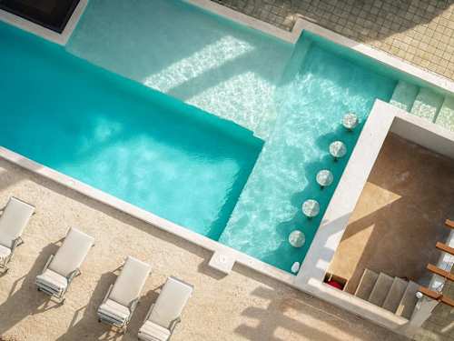 Resort-style shared pool surrounded by lounge chairs