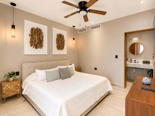 Bedroom 1 with king-size bed, ceiling fan and tasteful decor