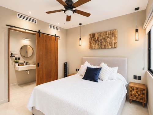 Serene bedroom with barn door and vanity mirror