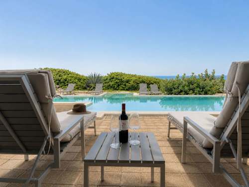 Private terrace with seating and pool views
