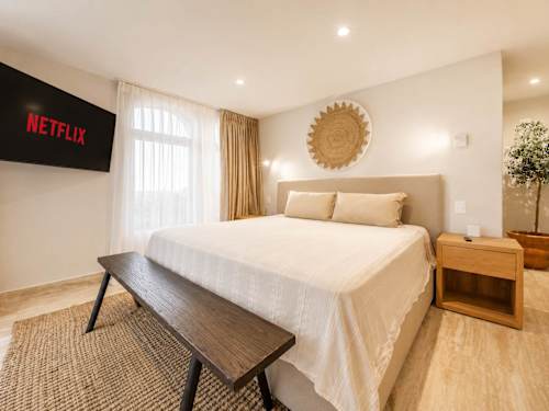 Bedroom with comfortable bed and central A/C.