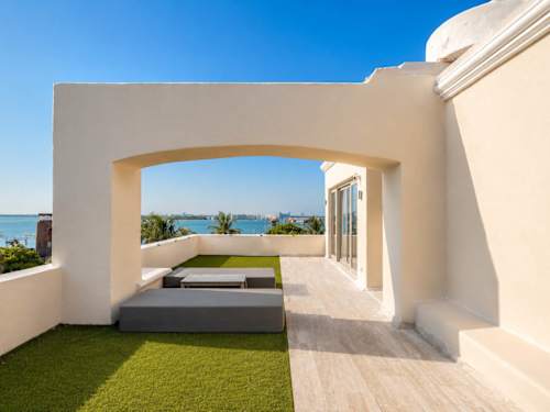 Private rooftop terrace with turf and lagoon views.