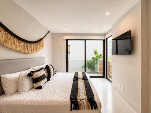 Bedroom with two double beds and TV