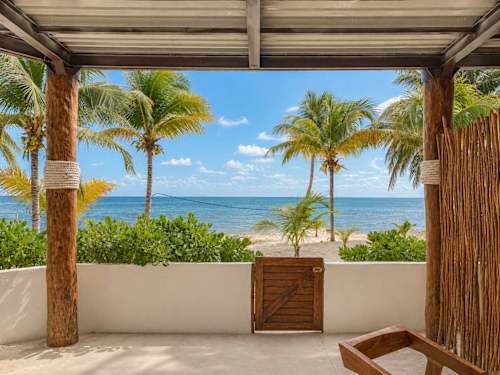 Private beachfront framed by palms