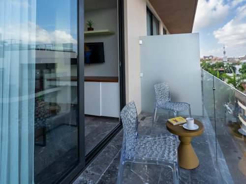 Private balcony nook with a chair and side table, a quiet corner for morning coffee or an evening drink