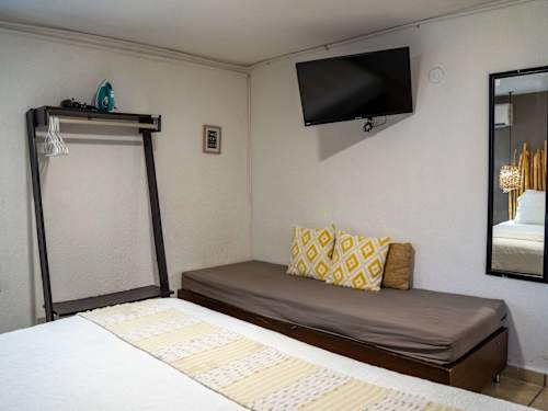 Bright living area with a sofa bed and smart TV, relax after a day exploring Cancun