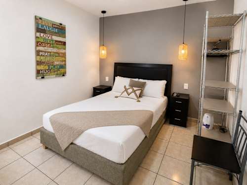 Cozy bedroom with fresh linens and extra shelving, steps from Market 28 and the ADO station