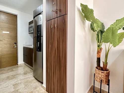 Handy kitchenette with fridge and ample storage for a comfortable self-catering stay