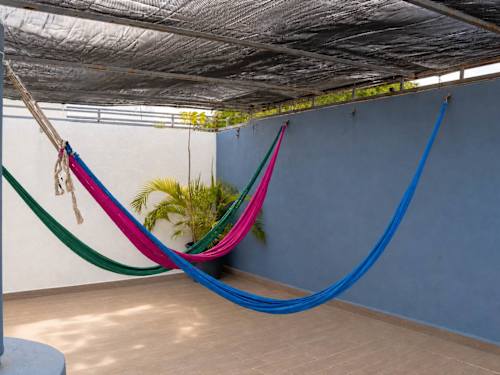 Twin hammocks under the palapa roof, an easy way to catch the rooftop breeze
