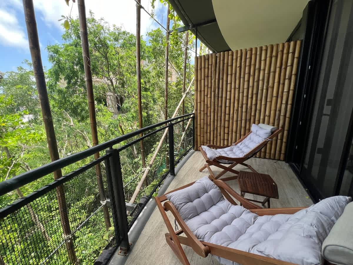 Private terrace with seating overlooking the greenery