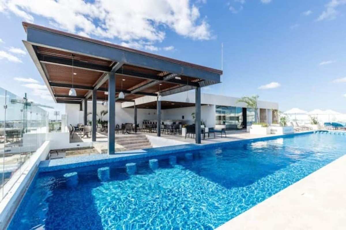 Shared rooftop pool with sea and city views