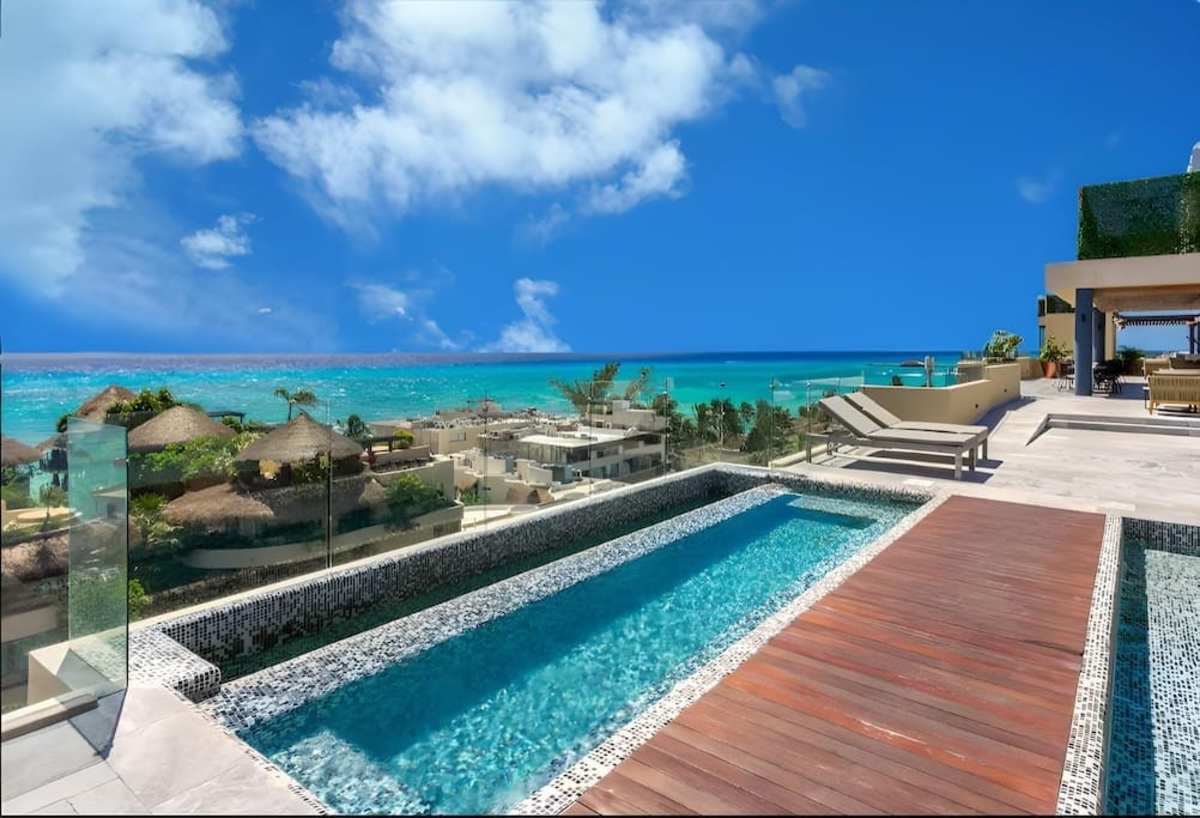 Shared rooftop pool with ocean views