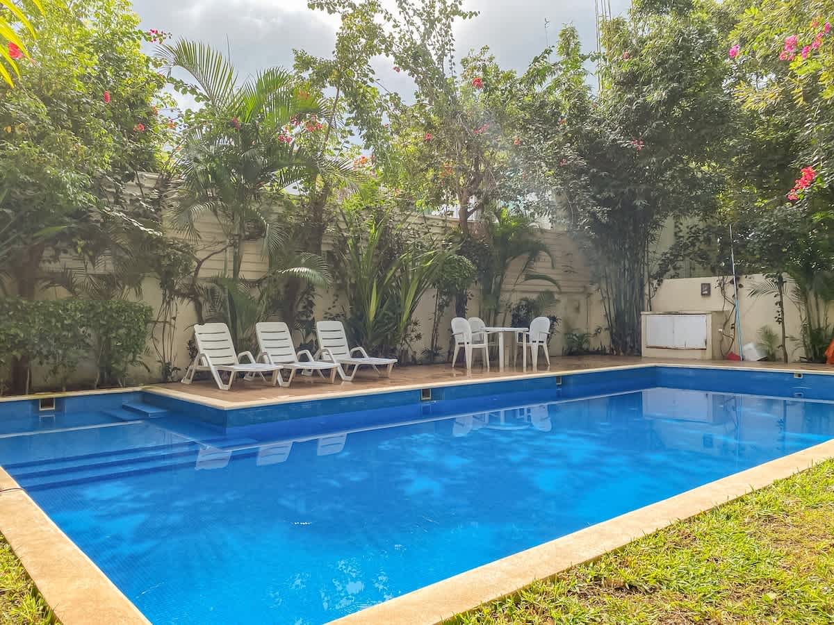 Shared communal pool with sun loungers