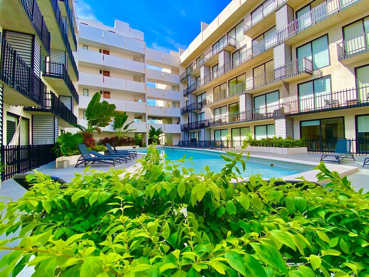 Building exterior with rooftop pool, aerial view