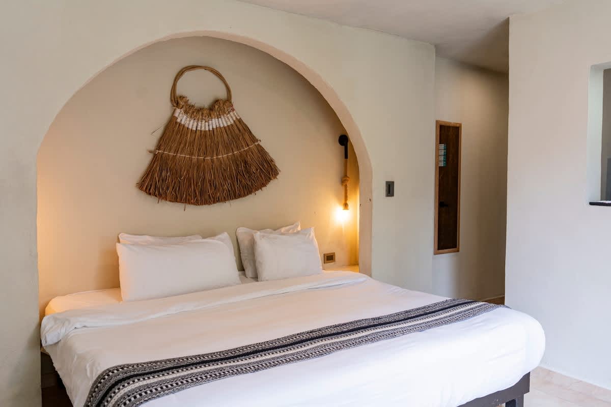 Studio with king bed and boho decor.