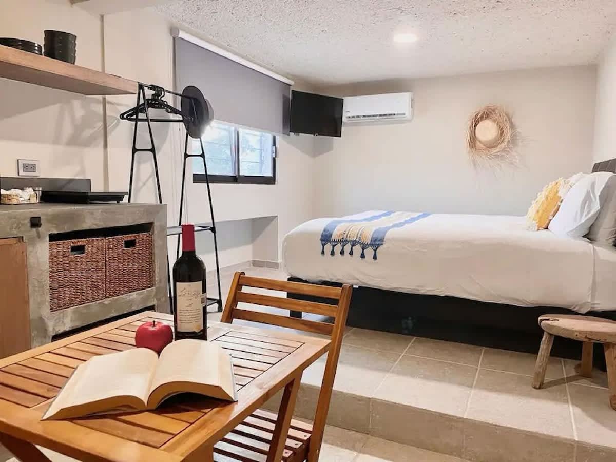 Open-plan studio with dining table and kitchenette