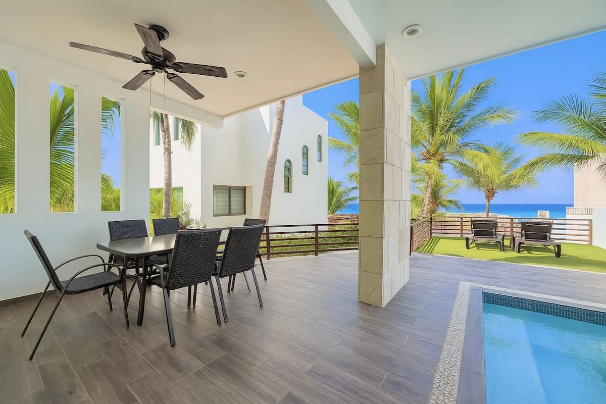 Bright open-plan living and dining area with modern furnishings and A/C