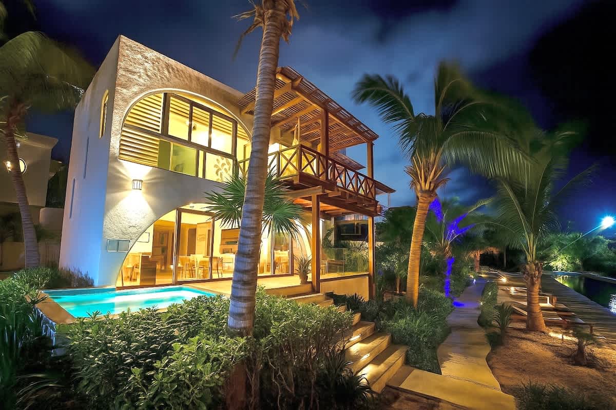 Villa exterior with private plunge pool at dusk