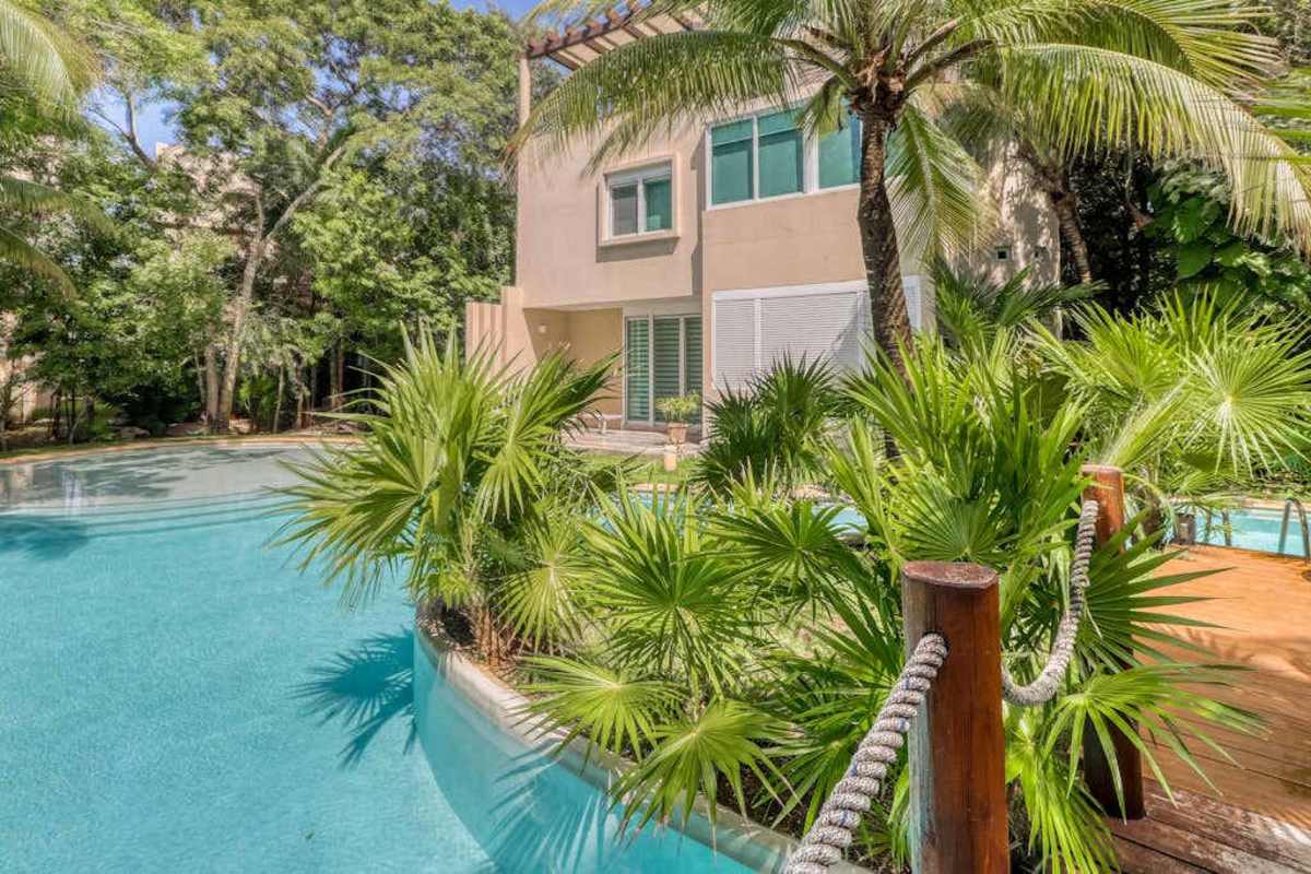 Shared community pool with tropical garden (common area)