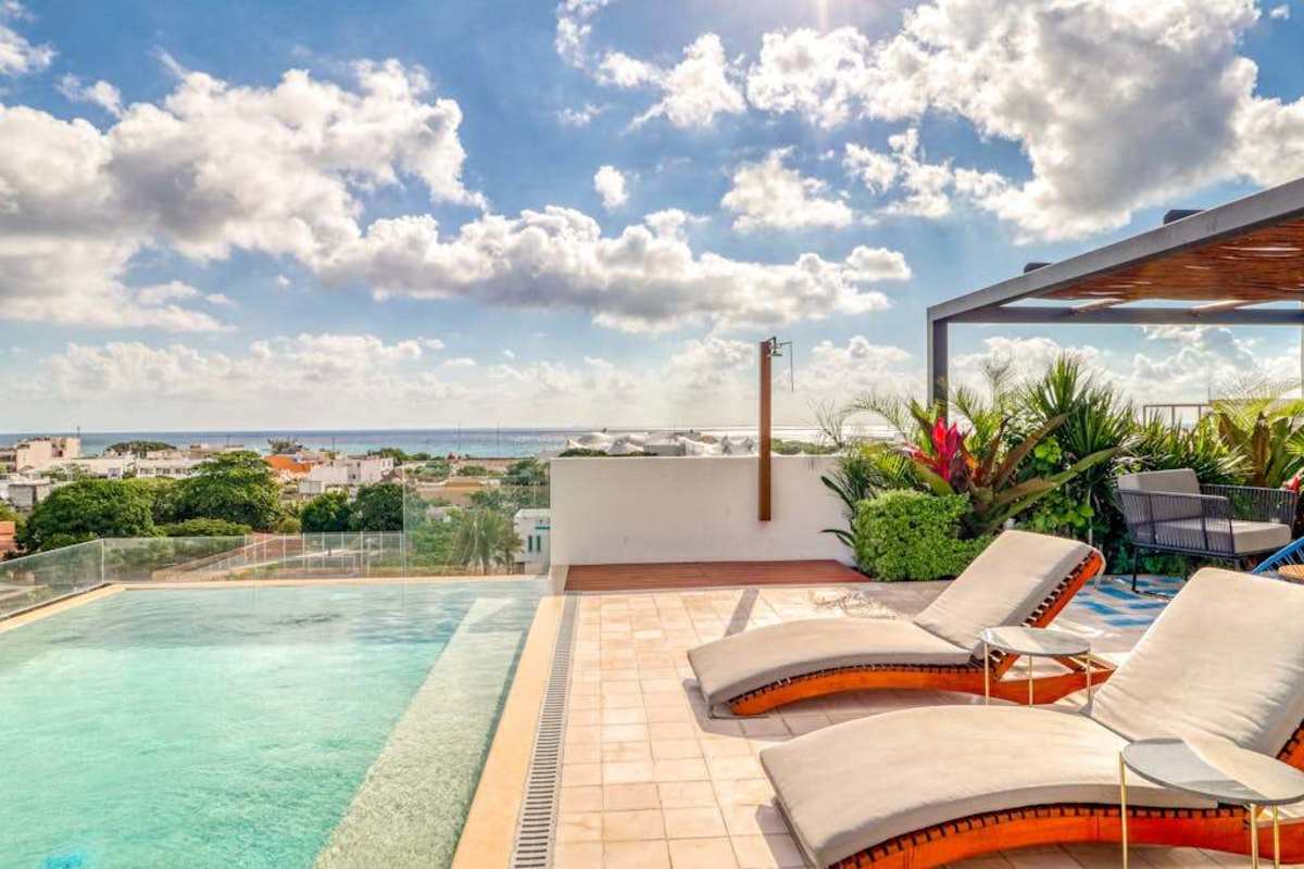 Shared rooftop pool with ocean and city views