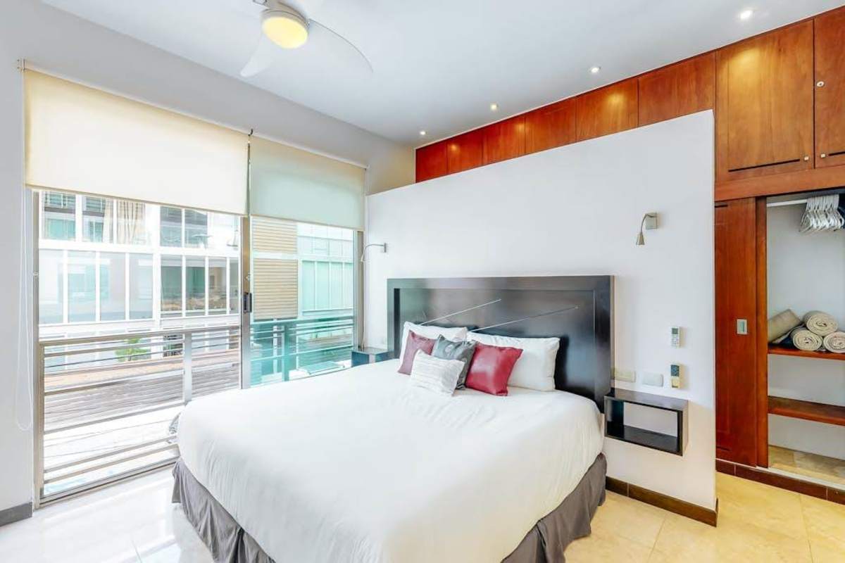 Bedroom with king-size bed and natural light.
