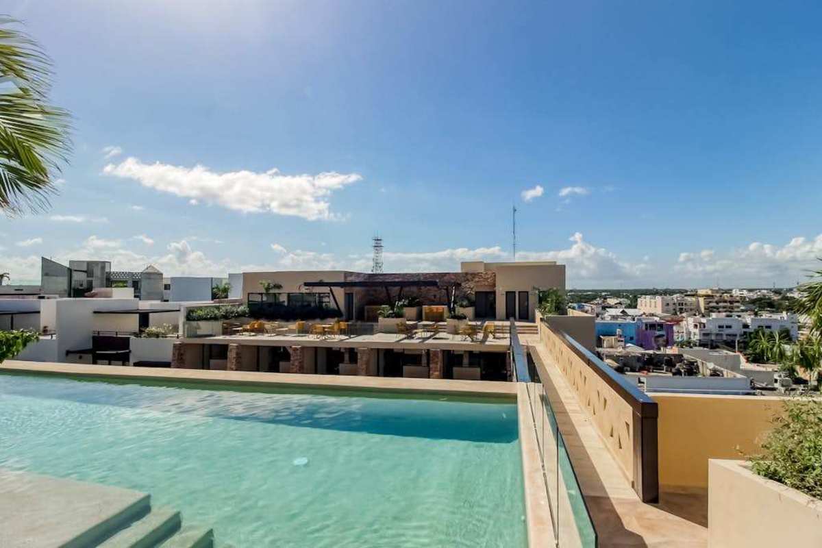 Shared rooftop pool with city and sea views