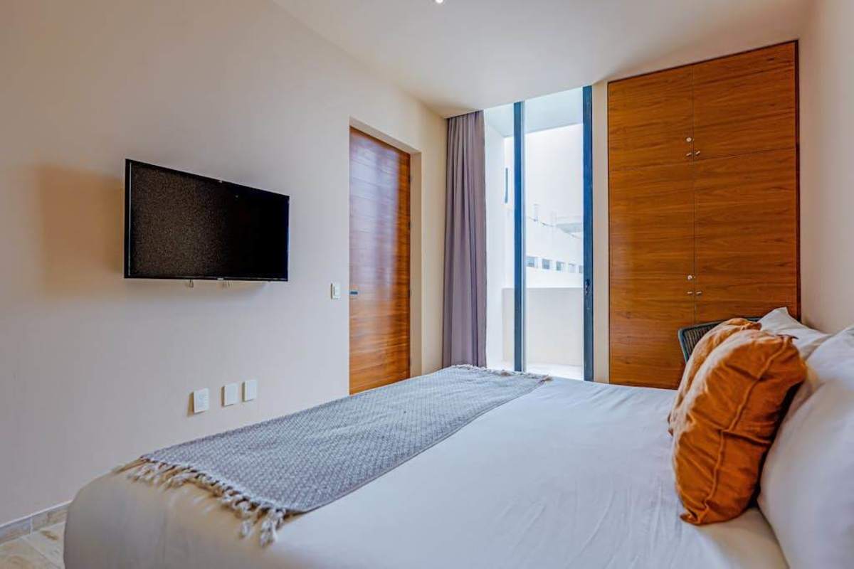 Bright living area with smart TV and balcony access