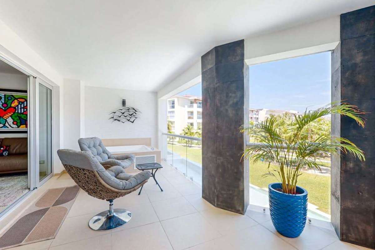 Bright living room with sofa and ocean-view balcony