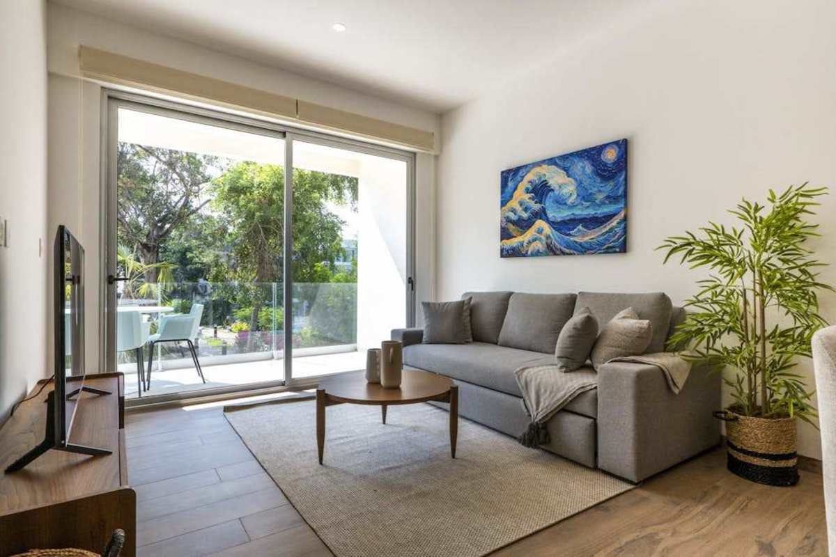 Bright living room with sofa and balcony