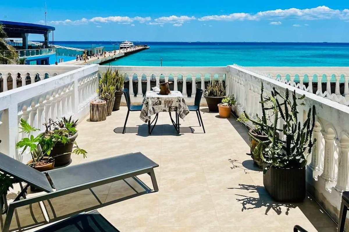 Private oceanfront terrace with seating and Caribbean views
