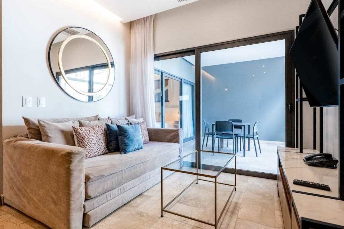 Bright living room with smart TV and ocean-view balcony