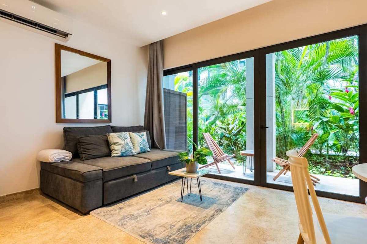 Living room with sofa bed and sliding doors to private balcony
