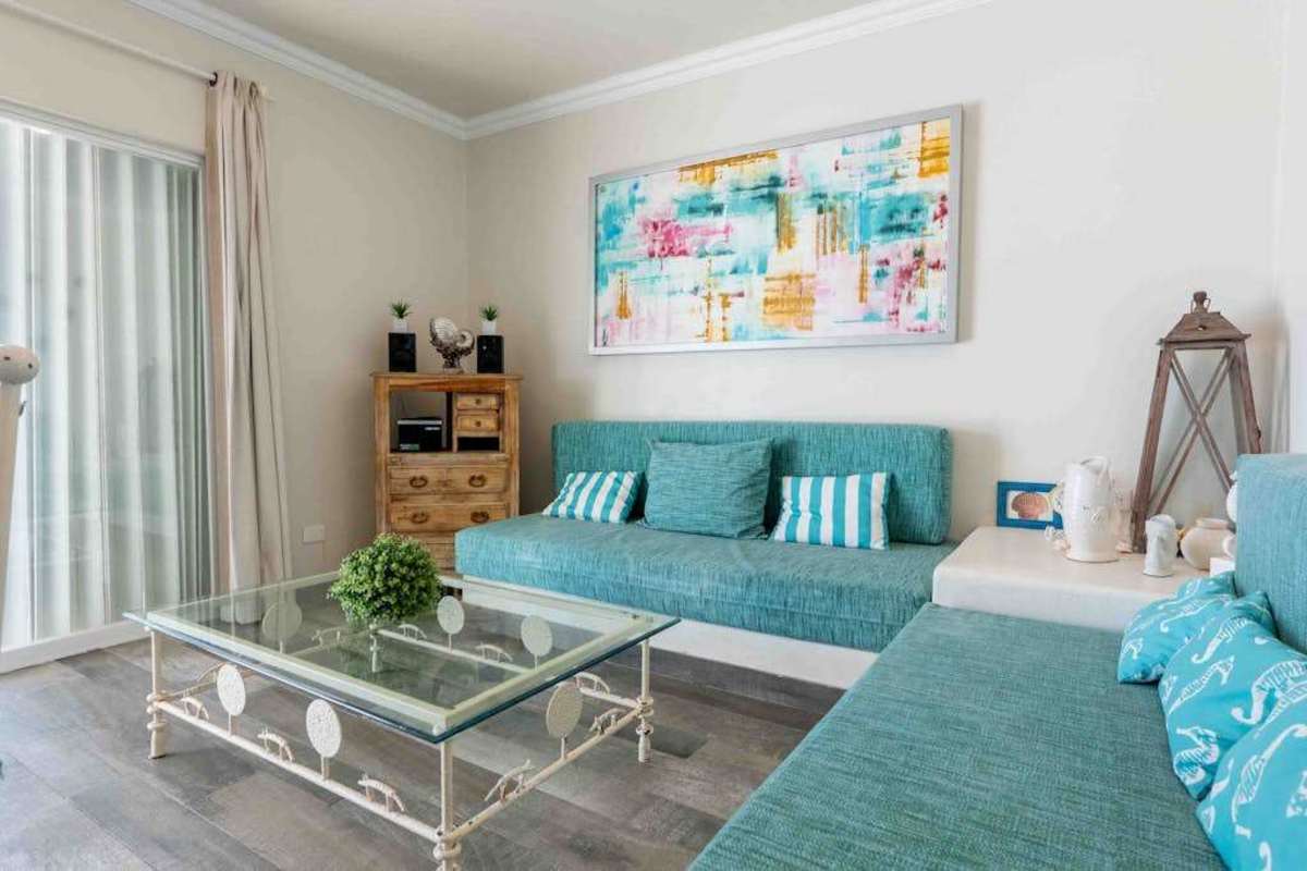 Bright living room with coastal decor and ocean-view balcony
