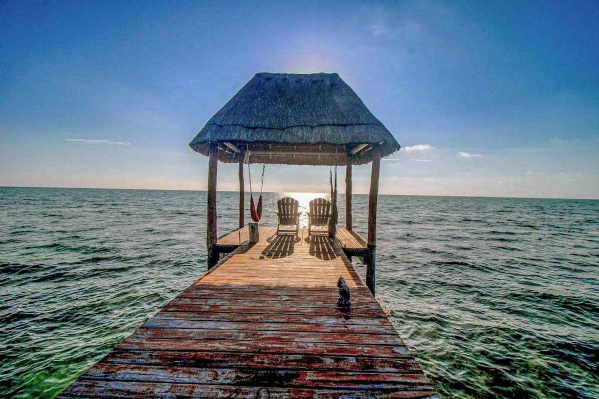 Private beachfront palapa deck over the water with loungers