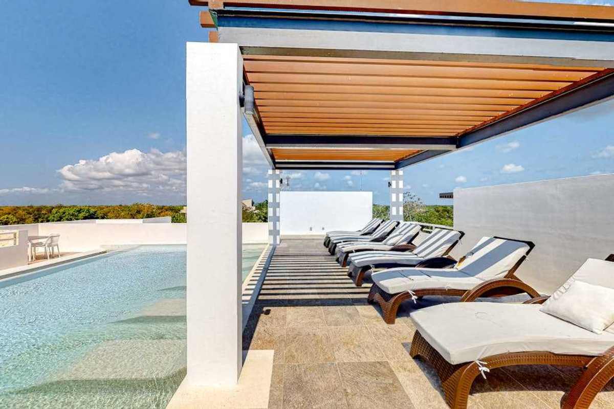 Shared rooftop lounge with shaded pergola